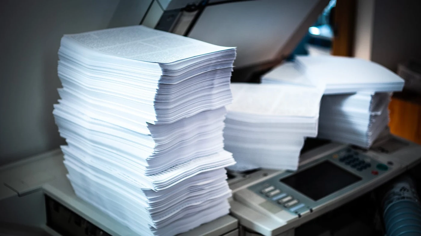 Stacks of printed corporate material and branded stationery from Soho Connect production work